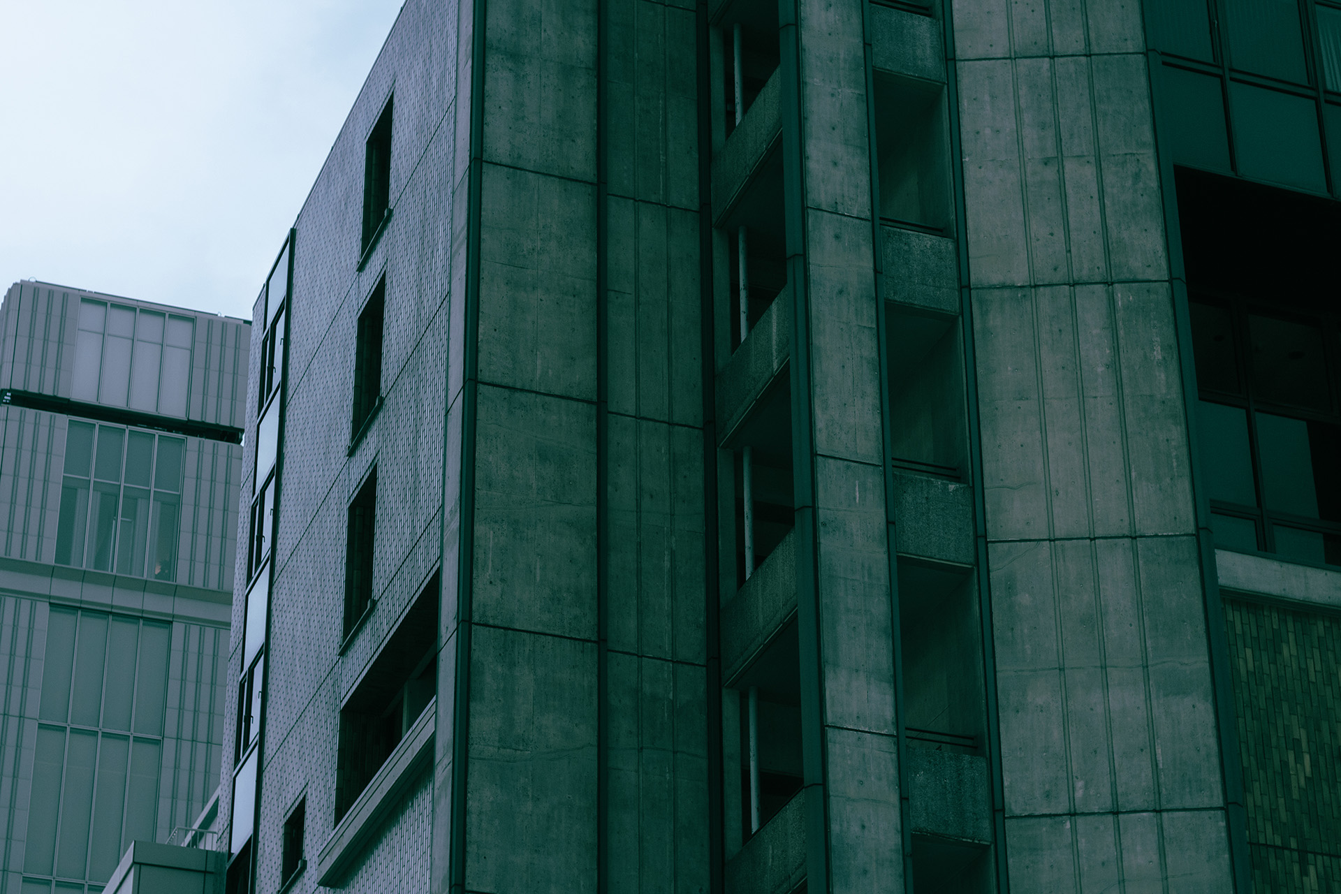 Close-up of a dark green concrete building.